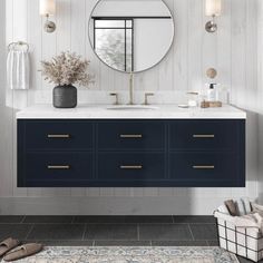 a bathroom vanity with two sinks and a large round mirror above it, along with a rug on the floor