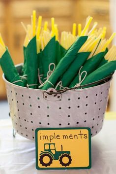 a bucket filled with yellow and green straws next to a sign that says simple men's