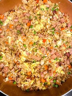 a pan filled with rice and vegetables on top of a stove