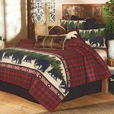 a bed room with a neatly made bed covered in plaid comforter and bear pillows