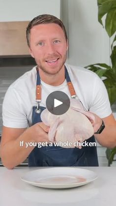 a man holding a chicken on top of a white plate