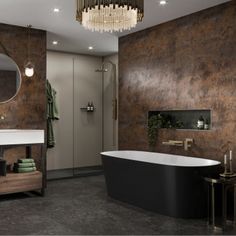 a bathroom with a tub, sink, mirror and lights on the wall above it