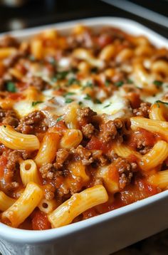 a casserole dish filled with pasta and meat