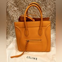 Celine Drummed Calfskin Luggage Ocre Luxury Yellow Bag With Zipper Closure, Luxury Yellow Bags With Zipper Closure, Luxury Textured Leather Yellow Bags, Luxury Yellow Textured Leather Bags, Yellow Textured Leather Travel Bag, Designer Yellow Bags With Leather Lining, Luxury Orange Soft Leather Bags, Luxury Yellow Bag With Leather Lining, Celine Bags