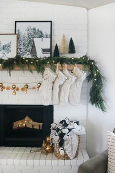 christmas stockings hanging from the mantle in front of a fireplace