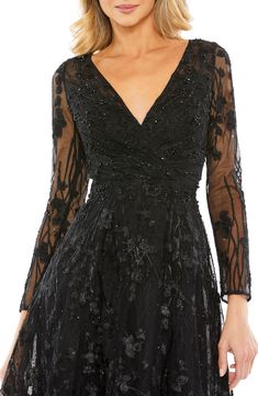 Gorgeous beading and sparkly sequins detail the floral lace of this event-ready cocktail dress cut in a fabulous fit-and-flare silhouette. 48 1/2" length Hidden back-zip closure Surplice V-neck Long sleeves Partially lined 100% polyester Spot clean Imported Asian Owned/Founded Short Wedding Guest Dresses, Designer Formal Dresses, Formal Dresses With Sleeves, Elegant Aesthetic, Black Bridesmaid Dresses, Mac Duggal, Gowns With Sleeves, A Line Gown, Long Sleeve Floral Dress