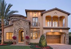 a large house with two garages and lots of windows