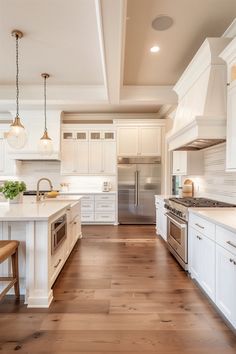 a large kitchen with white cabinets and wood floors