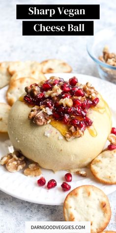 cheese ball with cranberry sauce and crackers on a plate next to it