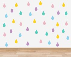 colorful raindrops on a white wall in a room with wooden floors and hardwood flooring