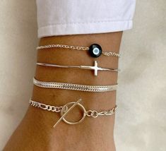 Make a statement with our stunning handmade silver bracelets. Crafted from the highest quality Sterling Silver 925, each piece is unique and eye-catching. Choose from our collection of four distinct designs, including an Evil Eye bracelet, an adjustable bangle with a Cross at the center, a chic chain bracelet, and a modern circle bracelet. Perfect for any occasion, our bracelets are the ultimate addition to your jewelry collection. Shop now and add a touch of elegance to your look. 👉  My Women Silver Stackable Chain Bracelet As A Gift, Silver Stackable Chain Bracelet Gift, Sterling Silver Stackable Chain Bracelet, Dainty Stackable Sterling Silver Bracelet As Gift, Modern Silver Stackable Chain Bracelet, Trendy Sterling Silver Bracelet As Gift, Trendy Sterling Silver Bracelet For Everyday, Minimalist Stackable Silver Chain Bracelet, Handmade Minimalist Chain Bangle Bracelet