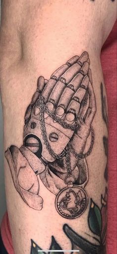 a man's arm with tattoos on it and an image of a baseball glove