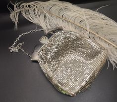 Absolutely stunning vintage Whiting and Davis silver metal mesh wristlet purse. This beauty has a white color silk lining interior. The silver tone scrolled frame has a very ornate clasp closure that works perfectly. This clasp shines with 1920's style and diamond gems. The inside of the frame is stamped Whiting and Davis,  Made in USA and the number 2957. Small chain strap has a 4" drop. There is very little wear noted exterior of this beautiful purse. Inside has a stain but no rips and is not coming apart from the frame it is as if it was frozen in time just gorgeous! 3 1/2" top to bottom  5 1/2" across  A lovely and unique vintage piece Silver Rectangular Coin Purse For Wedding, Elegant Silver Rectangular Coin Purse, Vintage Silver Rectangular Coin Purse, Silver Antique Evening Bag, Silver Clutch Coin Purse For Formal Events, Silver Rectangular Coin Purse For Evening, Vintage Silver Bag For Events, Silver Vintage Bag For Events, Antique Silver Bags For Vintage Events