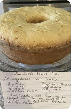 a cake sitting on top of a glass plate next to a note that says miss dot's pound cake