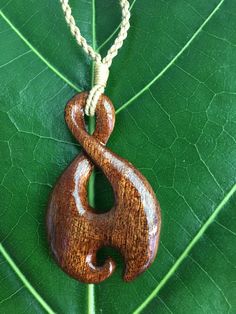 "KOA WOOD Tribal Design Pendant with Adjustable Cotton Cord Necklace Pendant: Approx. 1\" x 1.5\" Cord Necklace: Approx. 28\" long (Adjustable) This is a beautifully hand-crafted pendant made of natural koa wood in a traditional Polynesian spiral design. Brown braided cotton necklace has an adjustable sliding knot to adjust the necklace into any desirable length. Wear it close to your neck as a choker or longer as a pendant/necklace. Keep in mind the shade of pendant might varies cause of natura Handmade Adjustable Wood Jewelry, Adjustable Carved Brown Necklace, Artisan Jewelry With Adjustable Cord In Natural Color, Adjustable Natural Wood Pendant Jewelry, Adjustable Carved Natural Color Necklaces, Adjustable Natural Color Carved Necklaces, Adjustable Wood Jewelry Nature-inspired, Natural Carved Adjustable Jewelry, Natural Color Carved Adjustable Jewelry