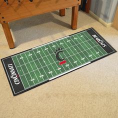 a football field rug on the floor next to a foo pad