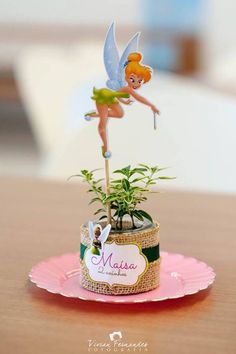 a small potted plant with a tinker fairy on top