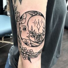 a person with a tattoo on their arm that has a clock and flowers around it