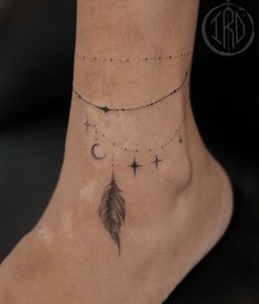 a woman's foot with a feather and stars tattoo on the bottom of her ankle