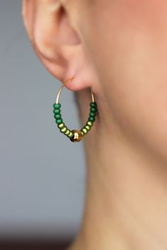 Minimalist hoop earrings with two types of green glass seed beads (shiny and matt), gold tone stainless steel beads and gold tone stainless steel round hoop earrings. Earring hooks are from nickel free and lead free metal. Perfect jewelry for everyday wear or a great gift for someone special! Diameter of hoops is 25 mm. Other earrings of my shop you can see here: https://www.etsy.com/shop/NaTavelli?section_id=13757927 Thanks for visit. Green Hoop Earrings With Tiny Beads, Green Small Hoop Beaded Earrings With Tiny Beads, Green Dangle Hoop Earrings With Tiny Beads, Green Hoop Beaded Earrings With Dangling Beads, Green Small Hoop Earrings With Tiny Beads, Green Small Hoop Jewelry With Tiny Beads, Green Tiny Beads Small Hoop Jewelry, Green Round Jewelry With Tiny Beads, Green Jewelry With Tiny Beads