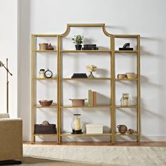 a living room filled with furniture and a book shelf next to a wall mounted lamp