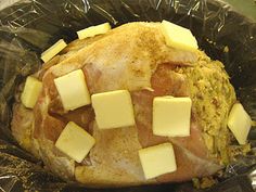 a chicken in a plastic bag with some cheese on the top and sides, ready to be cooked