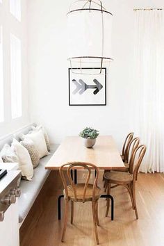 a dining room table with chairs and a bench