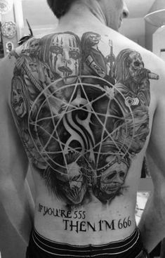 the back of a man with tattoos on his body and an inverted pentagramil