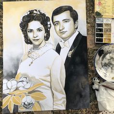 a drawing of a bride and groom on the ground next to some paintbrushes