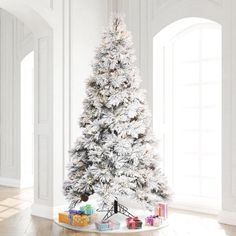 a white christmas tree with presents under it