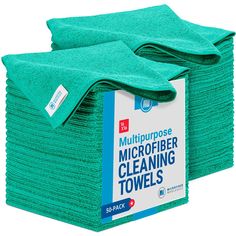 the microfiber cleaning towels are stacked on top of each other, one green