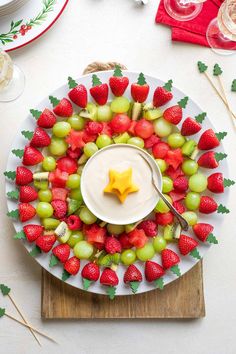 This Christmas Fruit Kabobs Wreath is perfect as an easy Christmas party appetizer, or as a fun alternative to fruit salad for a holiday brunch menu! The Christmas Fruit Wreath is so quick to make, and you can swap in different fruits or make it ahead for a potluck. We even show you how to make festive fruit cut-outs if you're feeling extra-fancy! Pile the pretty little fruit skewers as high as you'd like, to create a Christmas fruit platter for any number of guests. | www.TwoHealthyKitchens.com Fruit Skewers Christmas, Fruit Platter Easy, Christmas Fruit Platter Ideas, Christmas Fruit Kabobs, Fruit Skewers Ideas, Christmas Kabobs, Fruit Wreath Christmas, Skewered Fruit, Christmas Fruit Snacks