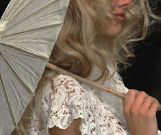 a woman holding an umbrella in her hand