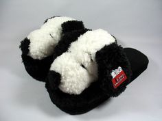 a pair of black and white slippers sitting on top of each other