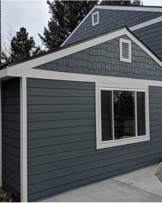 a gray house with white trim and windows