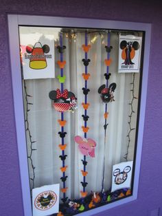 a display case with mickey mouse magnets on it's front and back sides