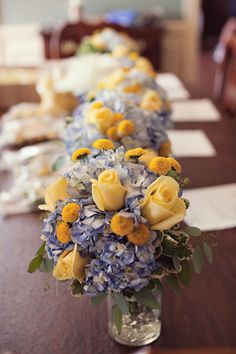 a long table with yellow and blue flowers