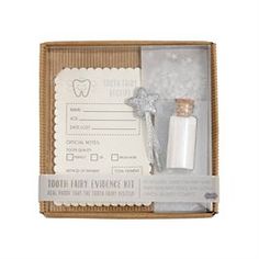 tooth fairy evidence kit in a cardboard box with silver stars on the top and a bottle