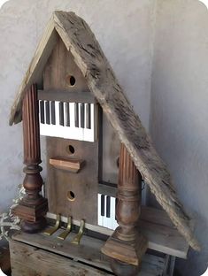 a bird house made out of wood with piano keys