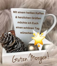 a coffee cup and some christmas decorations in a box with the words guten morgen on it