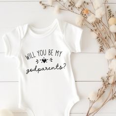 Make a heartfelt proposal to potential godparents with our "Will You Be My Godparents" baby bodysuit. This adorable garment is a thoughtful gift for godparents, perfect for proposing to godmothers, godfathers, aunties, and uncles for a christening or special occasion. Let this sweet gesture symbolize the bond between the child and their chosen guardians, creating a cherished memory for years. Godparent Announcement Ideas, Mother's Day Gift Fitted Onesie, Father's Day Family Matching Onesie, White Onesie For Mother's Day Gift, Mother's Day Gift White Onesie, Godparents Proposal Ideas, Gift For Godparents, Godparent Proposal, Godmother Proposal