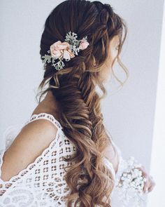 a woman with long hair and flowers in her hair