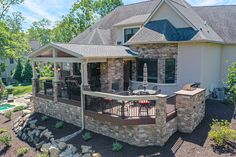 a house with a patio and grill in the front yard