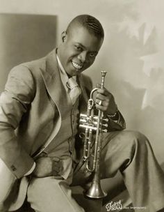 a black and white photo of a man holding a trumpet