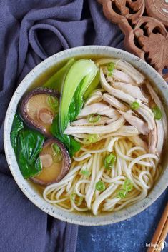 chicken noodle soup in a bowl with chopsticks