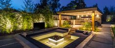 an outdoor living area with fire pit and lighting