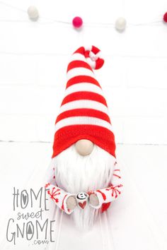 a red and white striped knitted santa clause hat