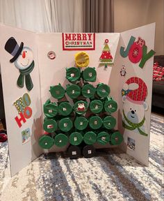 a christmas tree made out of cupcakes on display in front of a card