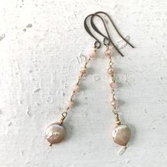 Dangle Earrings of Pale Pink Crystal Gold Bead Chain with a single gorgeous Pink Freshwater Coin Pearl! The coin pearls are bookended with tiny fluted gold plated metal beads and wire wrapped to the bead chain above. Hung on Gold Tone French Ear Wires, they make for the perfect pair of Neutral Elegance to add to your jewelry box. Measure 2 3/4 inches long and are full of swing and movement, yet oh so very lightweight and comfortable to wear. Enjoy these and other options coming soon too! Stand out from the crowd Penelope & Anastasia babes and follow the journey on IG & FB  @PenelopeAndAnastasia for first dibs on new items, SALE announcements, and in-person shopping opportunities! Xoxo ~ Pamela Pearl Beaded Chain Dangle Jewelry, Elegant Adjustable Beaded Earrings With Beaded Chain, Elegant Adjustable Beaded Earrings, Wire Wrapped Pearl Dangle Jewelry, Long Drop Beaded Chain Earrings As Gift, Elegant Beaded Chain Dangle Earrings, Bohemian Teardrop Pearl Jewelry, Elegant Czech Glass Jewelry With Dangling Beads, Handmade Long Drop Pearl Jewelry