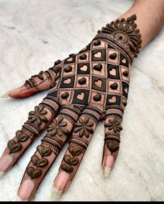 the hand is decorated with intricate designs and hearts on it's palm, which has been